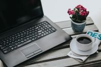 Kaboompics - Little pink flowers with a coffee and a black laptop