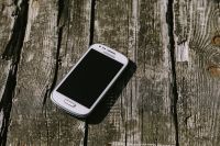 White smartphone on a wooden background